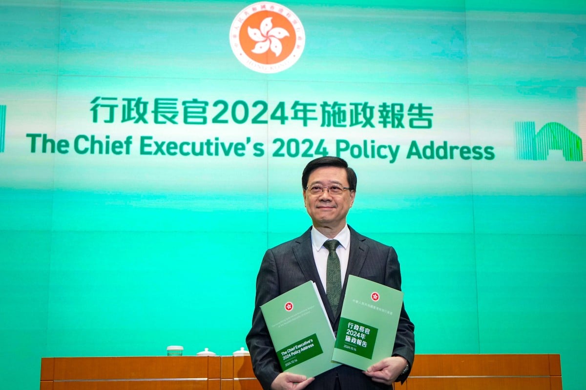 John Lee poses with copies of his latest policy blueprint. Photo: Eugene Lee