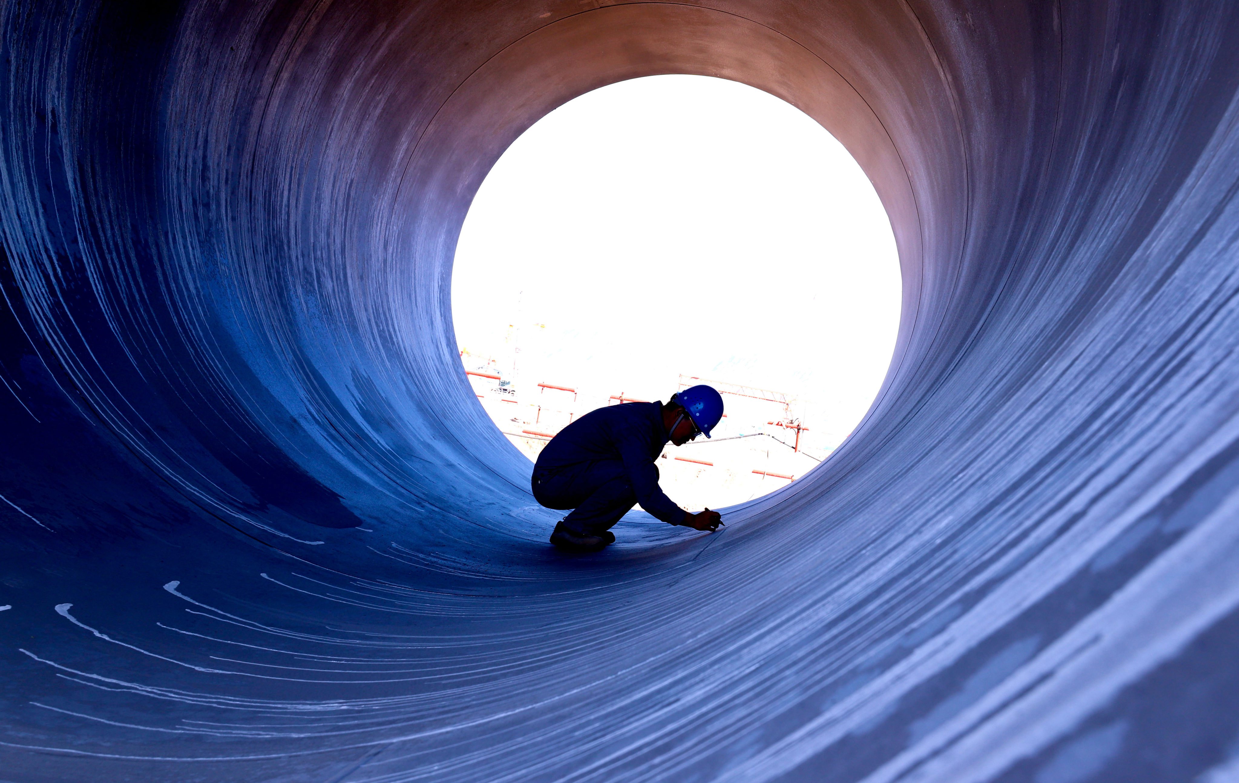 A water-circulation pipe is inspected at a construction site in China’s Gansu province. The nation’s economic planner has said 4 trillion yuan might be invested in urban pipework construction over the next five years. Photo: Getty Images