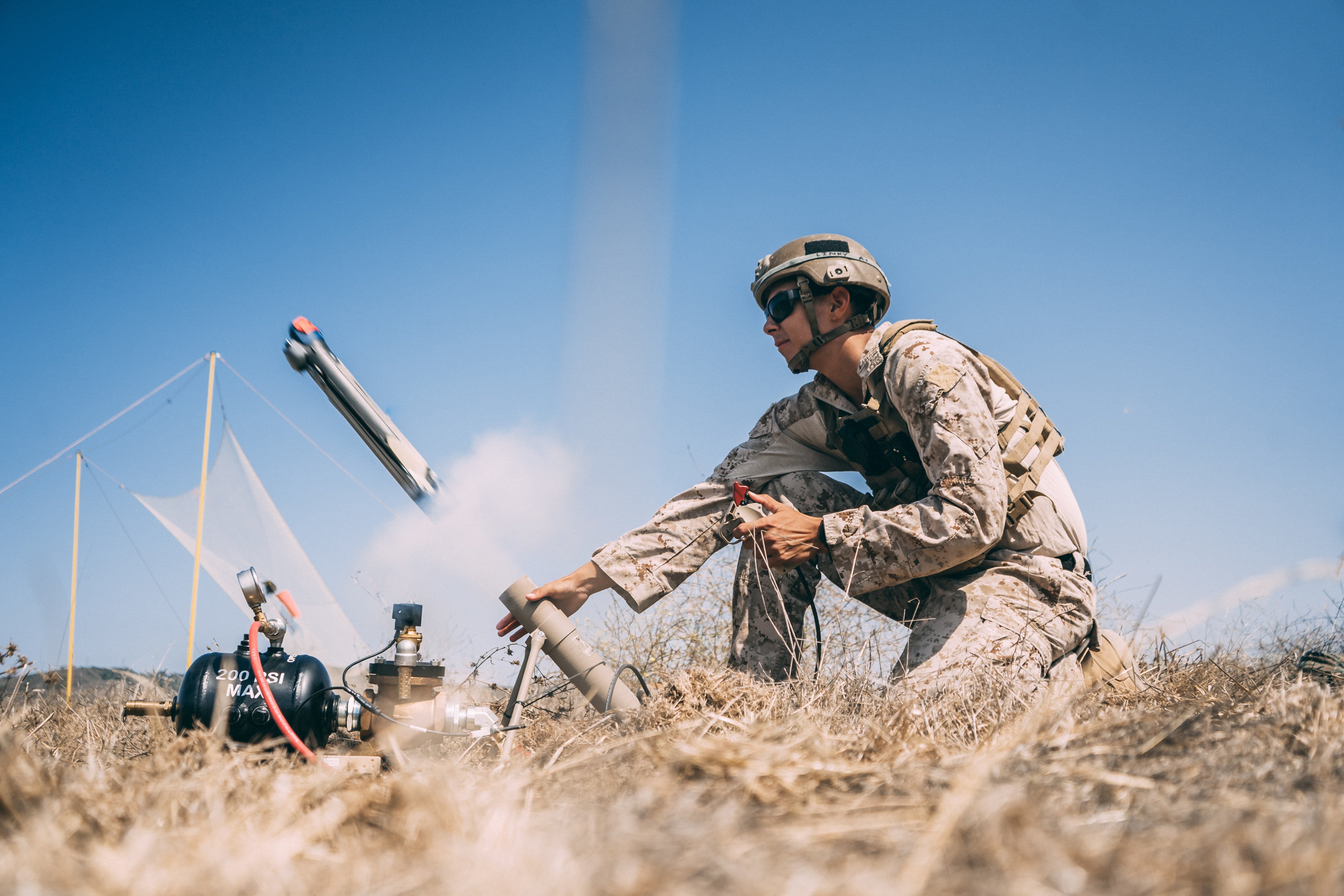 A member of the US Marine Corps launches a Switchblade 300 drone during a drill in California in September 2020. Photo:   Marine Expeditionary Force Information Group