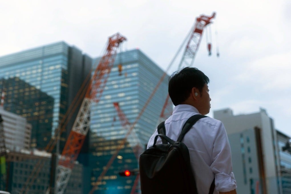 A pedestrian passes construction sites in Tokyo on September 18, 2024. Photo: Bloomberg