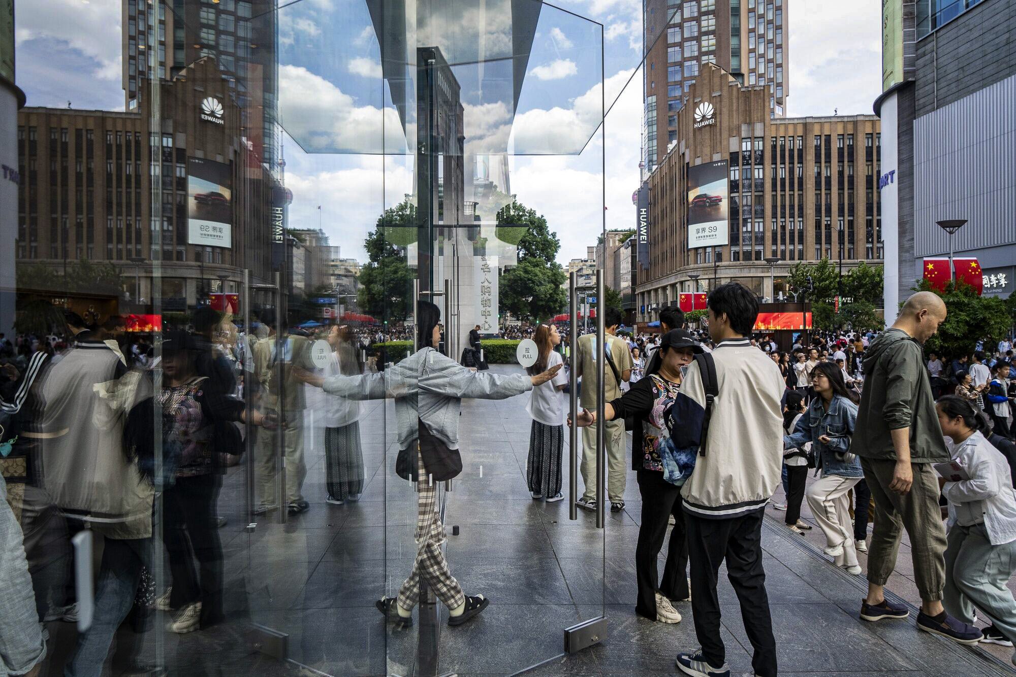 A customer exits an Apple store in Shanghai, China, on Wednesday. Consumers in the country are holding back on spending as the labour market remains weak and a property slump drags on. Photo: Bloomberg