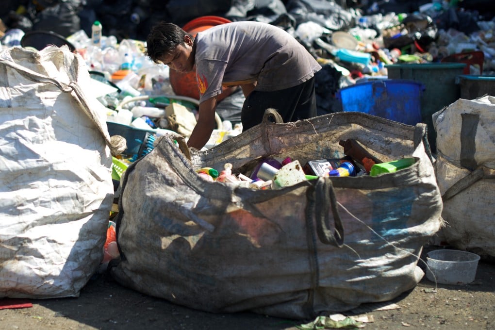 A worker sorts through plastic waste to recycle in the suburbs of Kuala Lumpur. Photo: AFP